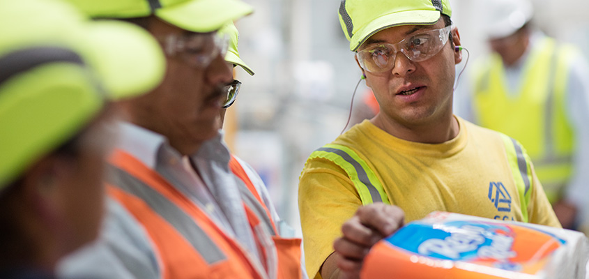 Factory workers inspect a pack of paper towels (photo)