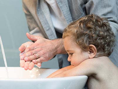 Man and infant at a washing basin (photo)